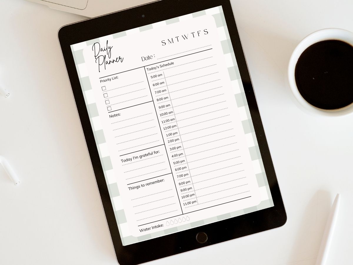 Flatlay image of an iPad displaying a free time blocking planner, with a cup of coffee nearby on a light-colored table—ideal for moms organizing their daily schedule.